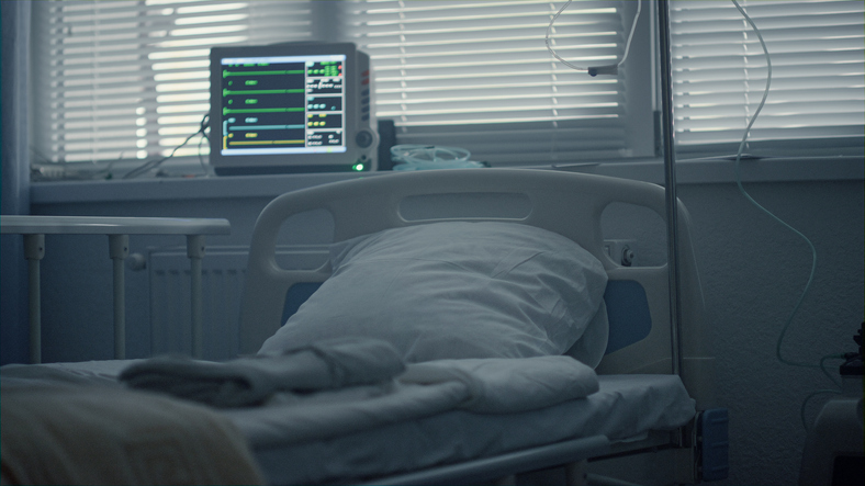 Empty hospital room interior with medical drip modern heartbeat computer screen.