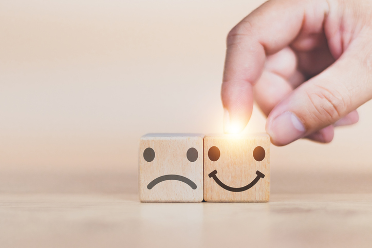 Customer service and Satisfaction concept man's hand is building a cube wood in the satisfaction rating the popular service company allows customers in order to improve and develop the organization