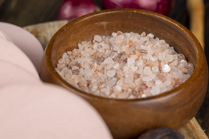 Pink natural salt on the table, close up