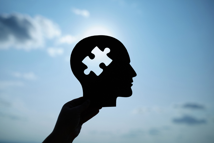 Concept of a human head with a puzzle in the middle