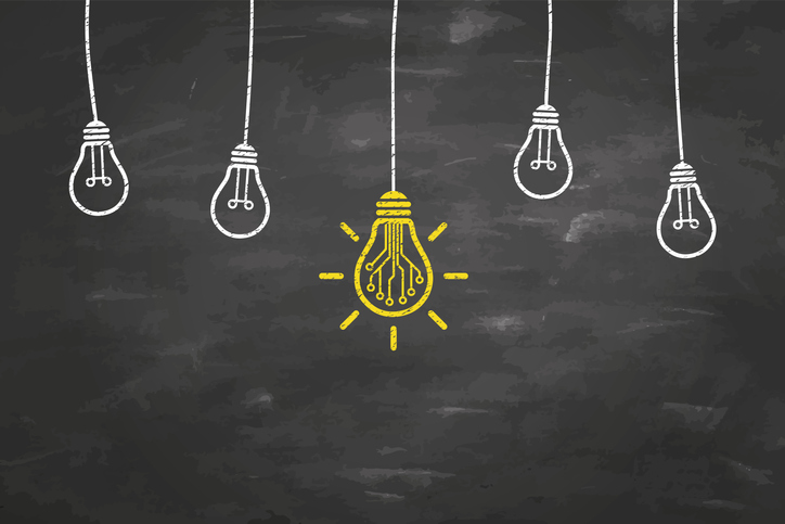 Innovative Idea Concepts with Light Bulb on Blackboard Background