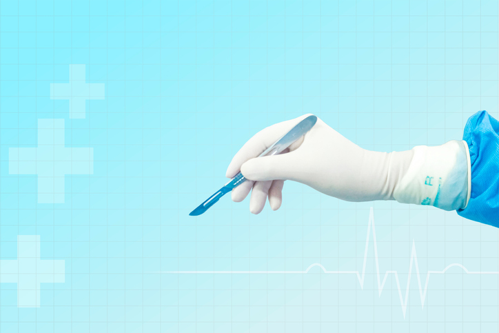 Doctor's hand holding a scalpel Background image of a doctor's hand holding a scalpel
