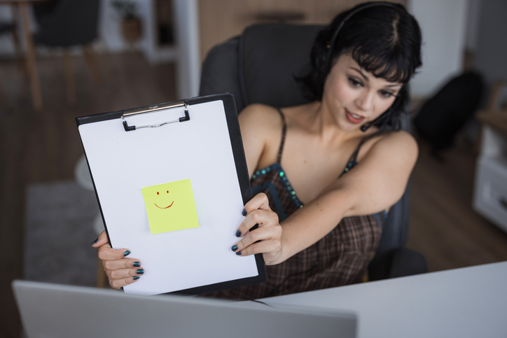 Happy young girl demonstrating note pad sticker emotion
