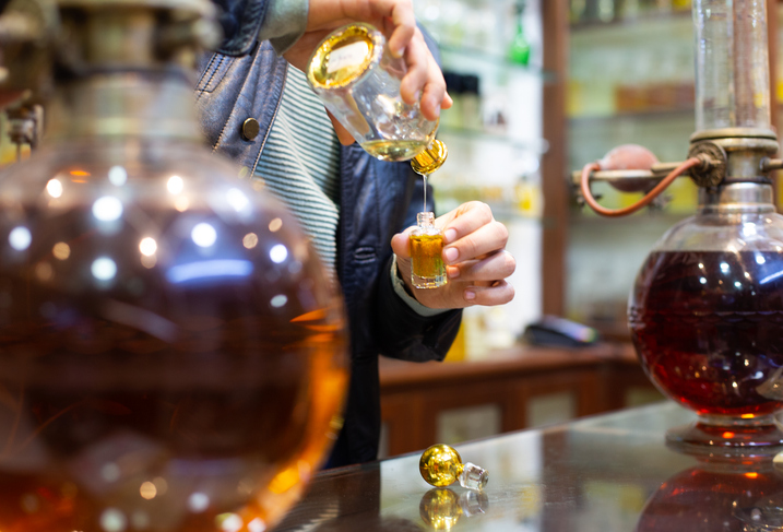 Perfumer in his store mixing essential oils to create individual perfume