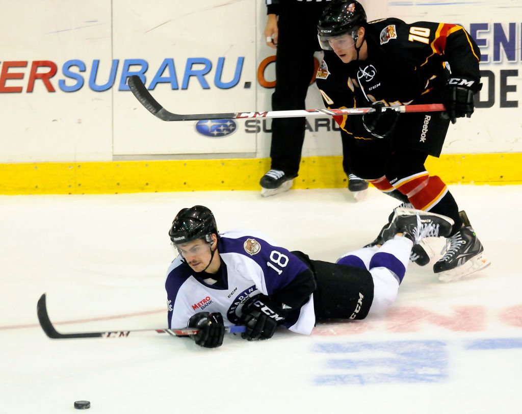 Reading's Domenic Monardo (18) falls in front of Cincinnati's Josh Birkholz (10).Reading Royals lose 4-1 to the Cincinnati Cyclones in a minor league hockey ECHL matchup at the Santander Arena, Reading. Photo by Jeremy Drey 11/29/2013