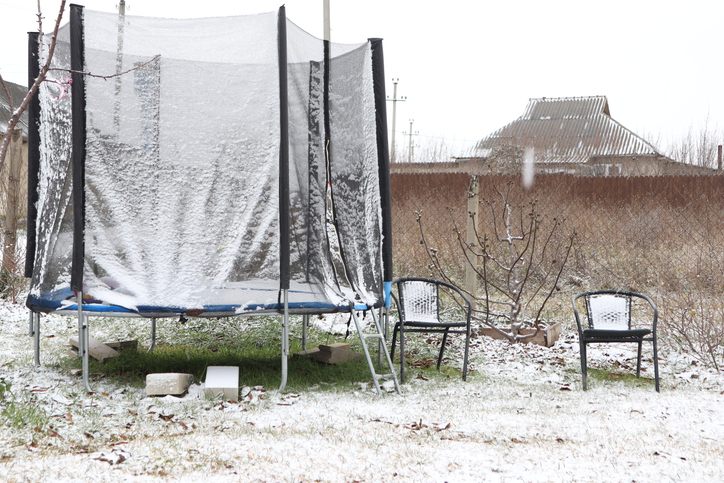 A lively trampoline set up in a picturesque Winter Garden Scene complete with snow and frost