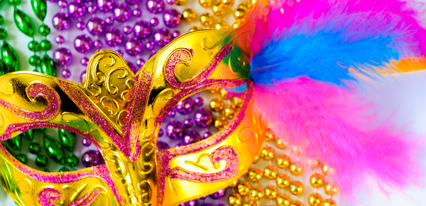 Golden carnival mask and colorful beads close-up. Mardi Gras or Fat Tuesday symbol.