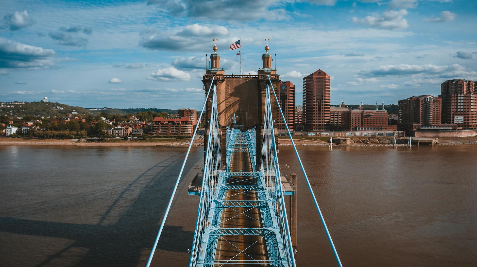 suspension bridge over river on sunny day