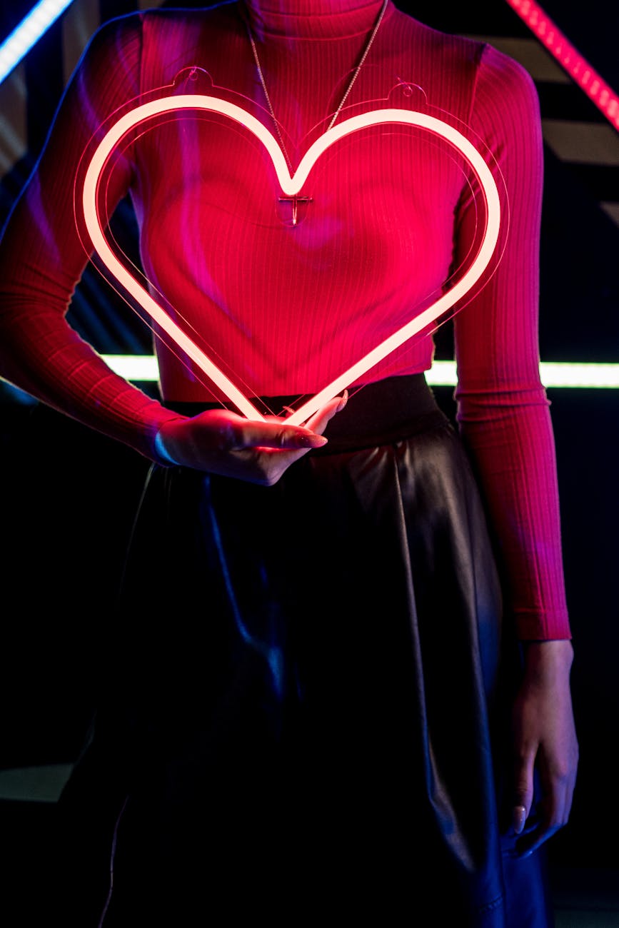 close up shot of a woman holding an illuminating heart