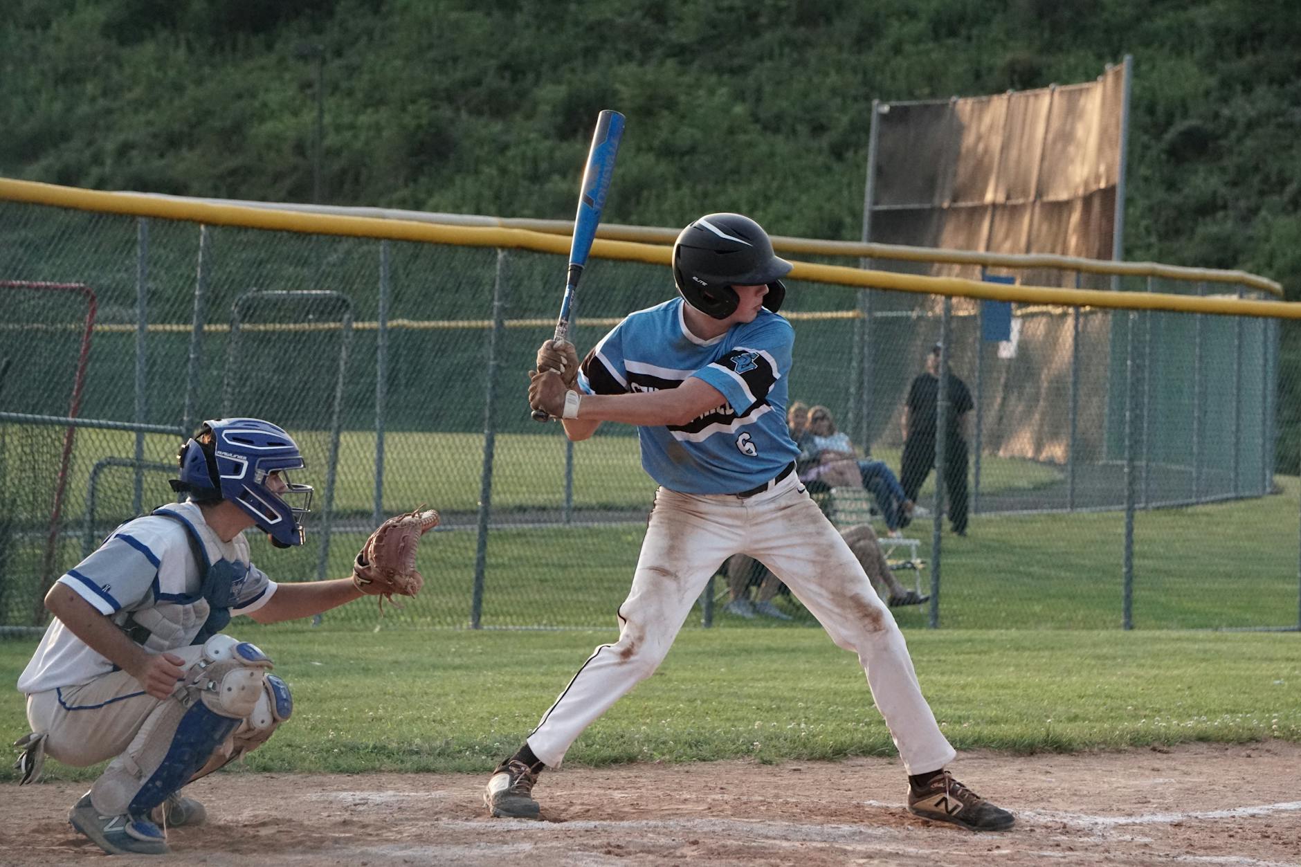man in blue and white jersey shirt and white pants playing baseball
