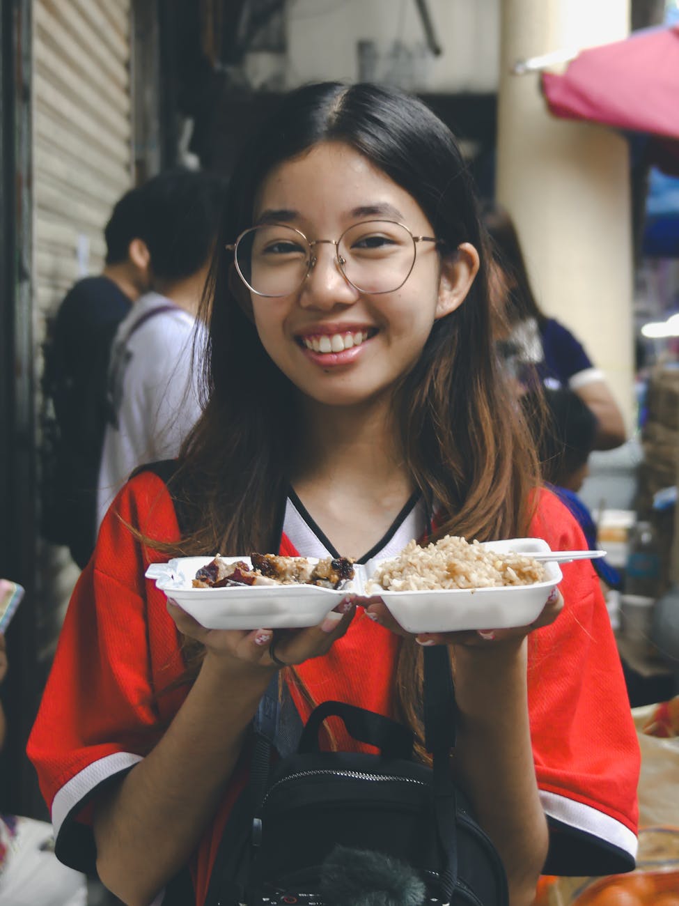 smiling woman enjoying street food in manila