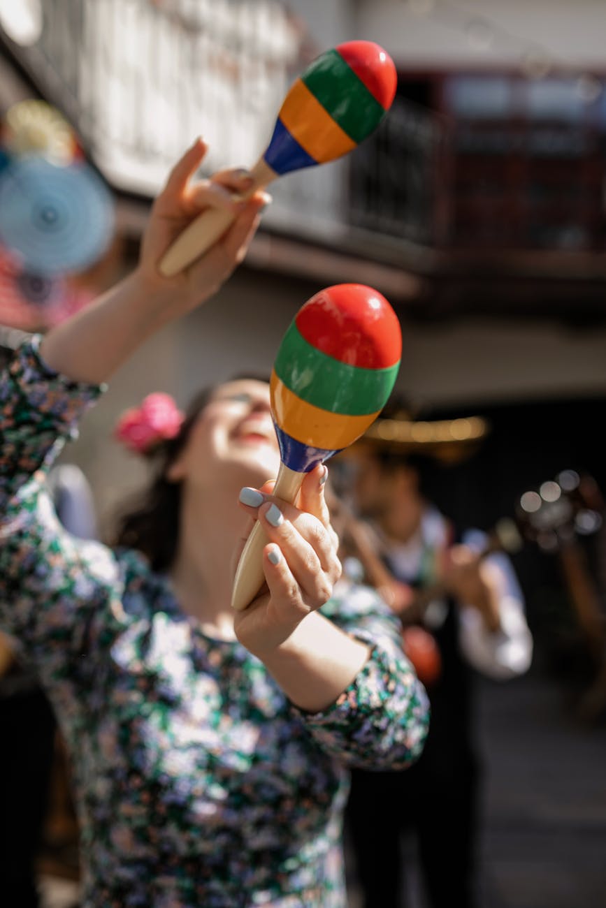 woman in floral dress playing maracas
