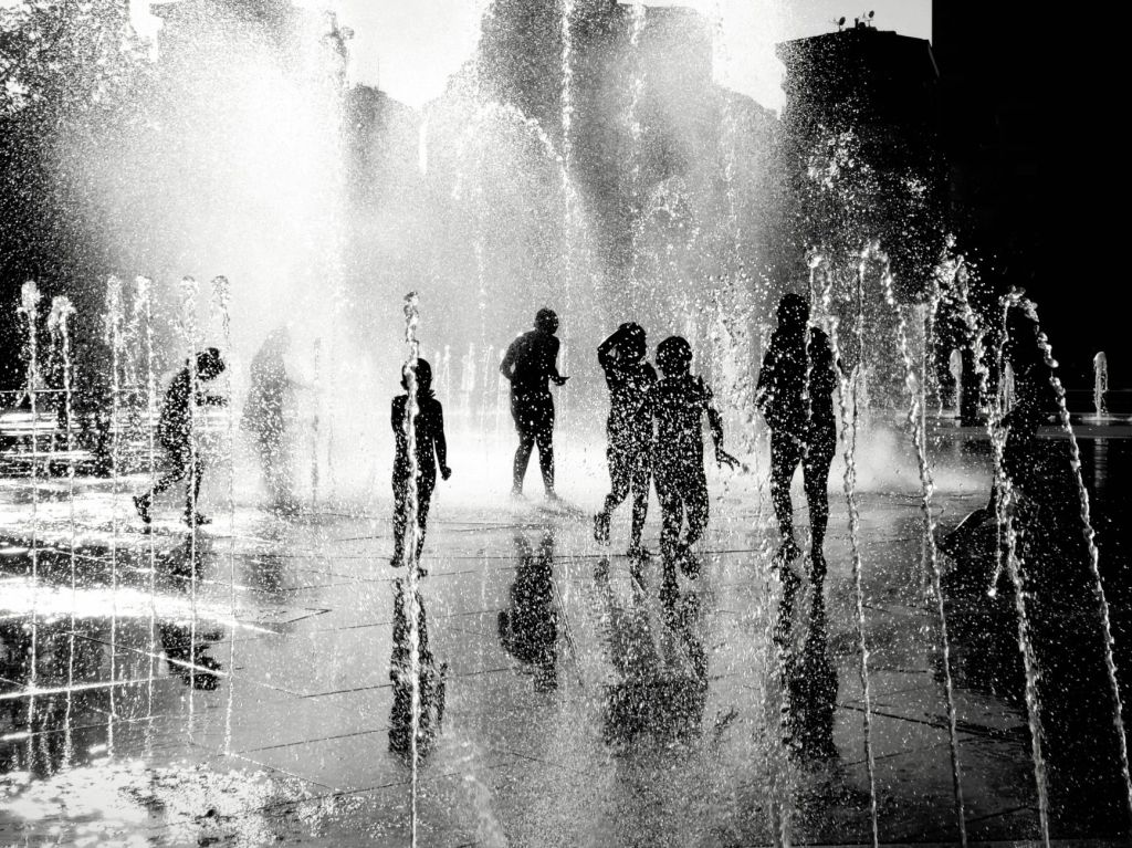 silhouettes playing in water fountain istanbul