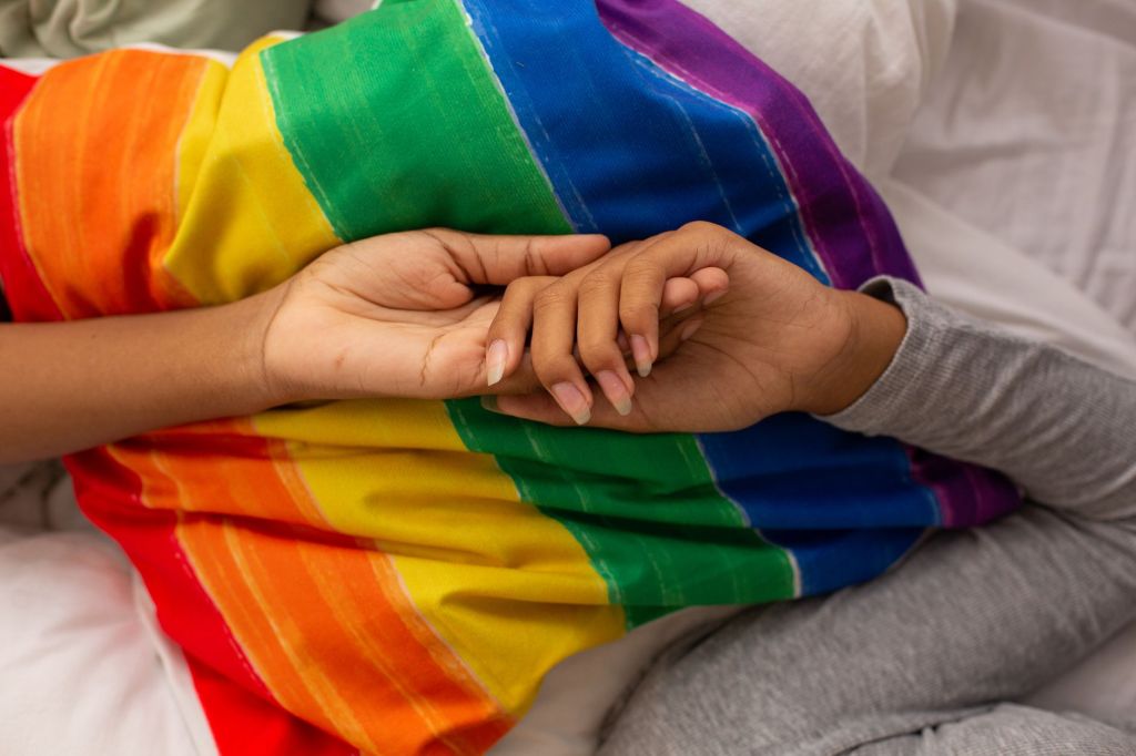close up photo of hands on top of pillow