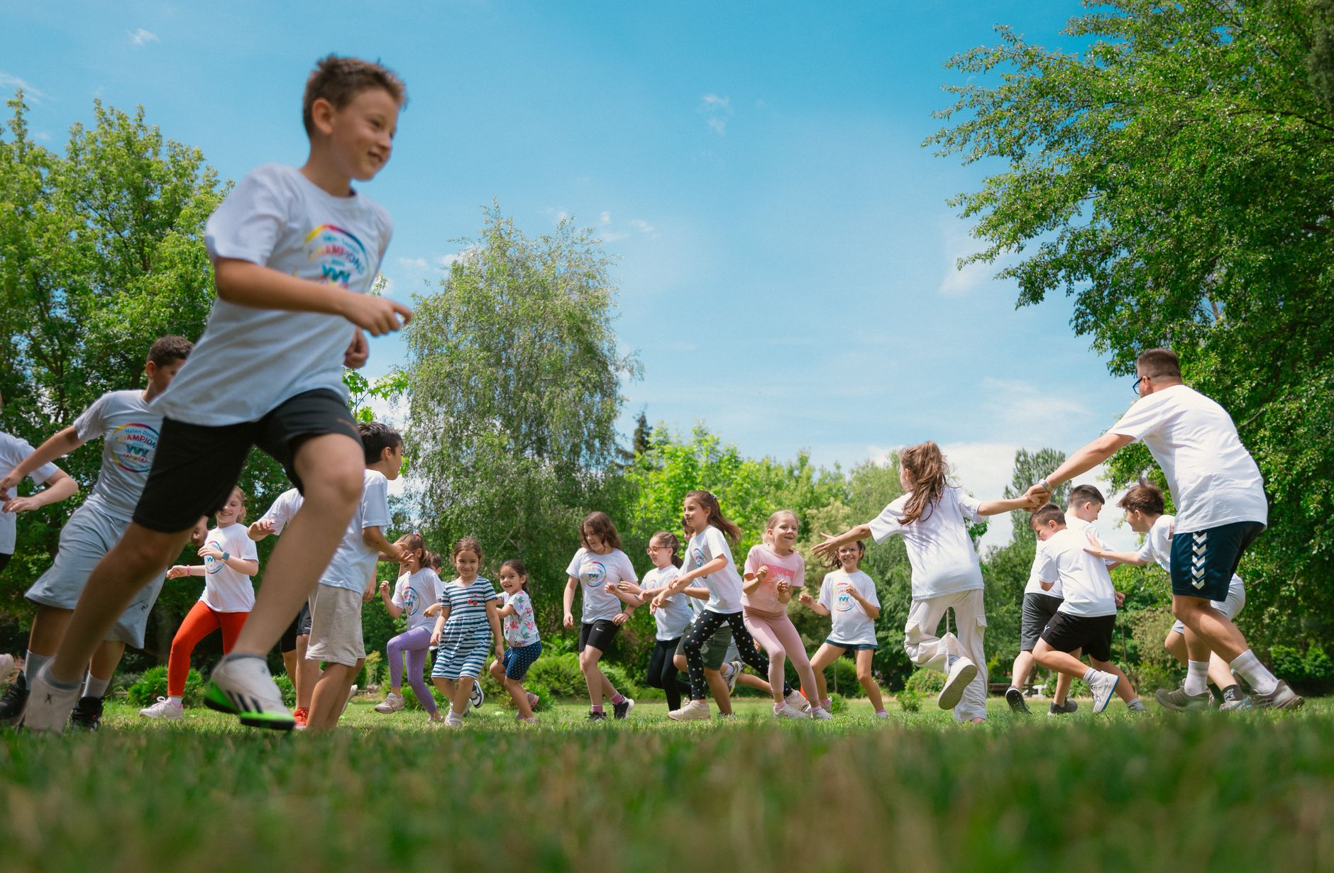 schoolchildren playing and exercising during an outdoor physical education class