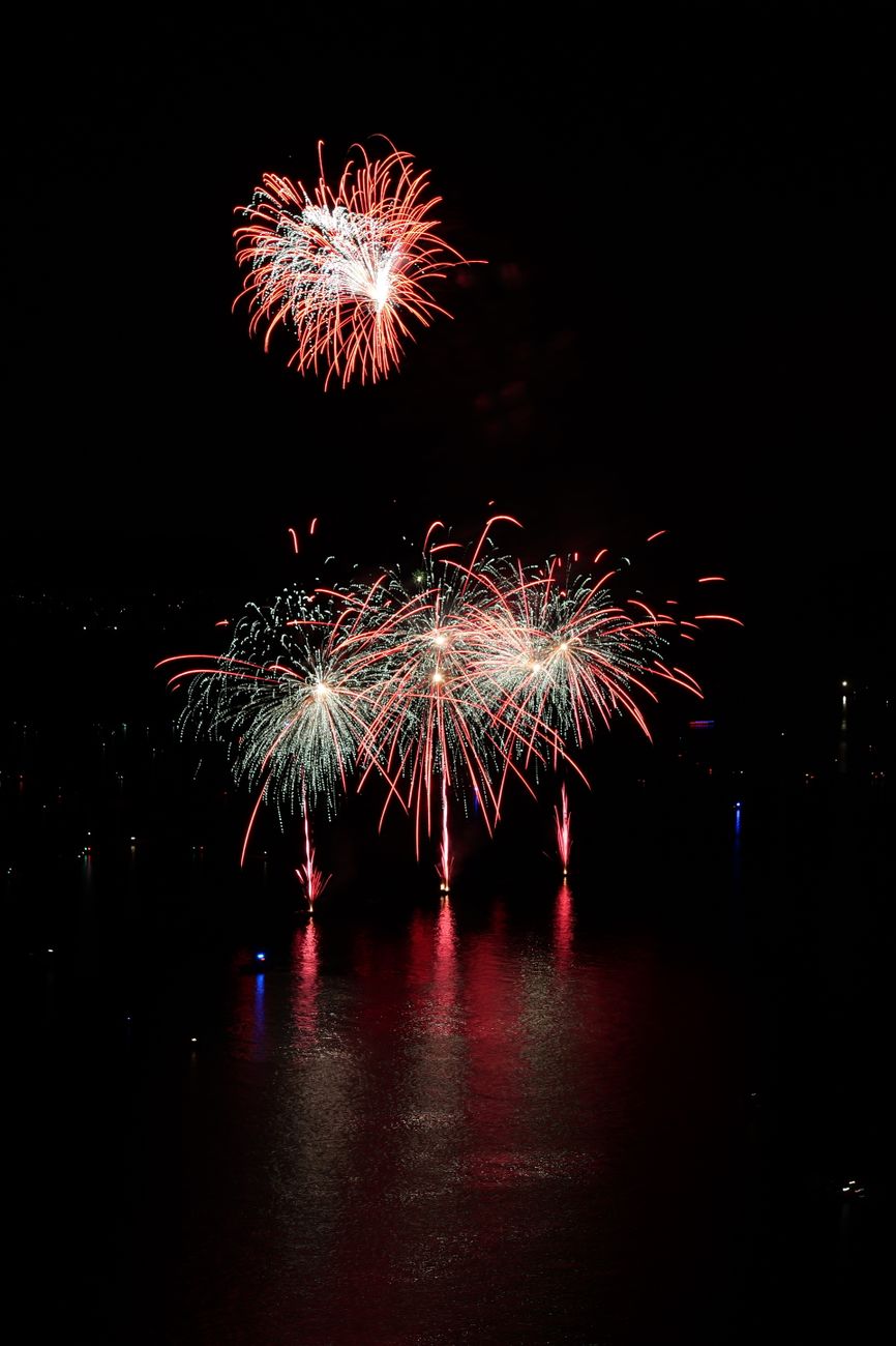 vibrant fireworks display over water at night