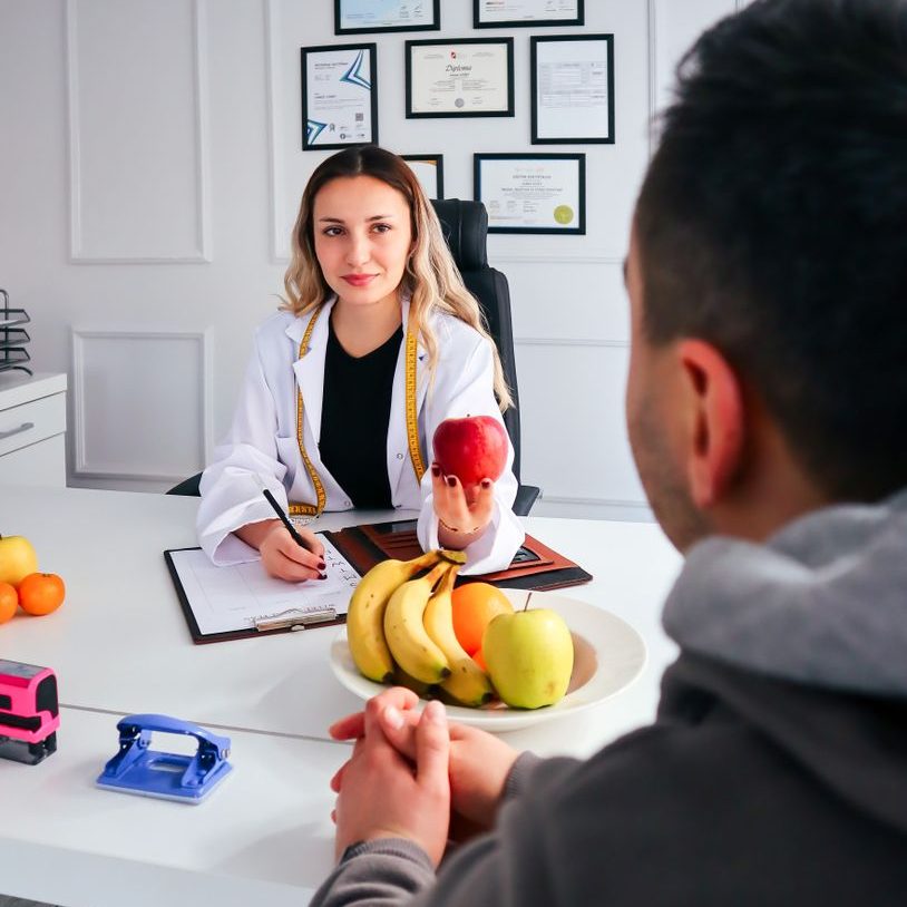 nutritionist giving apple patient