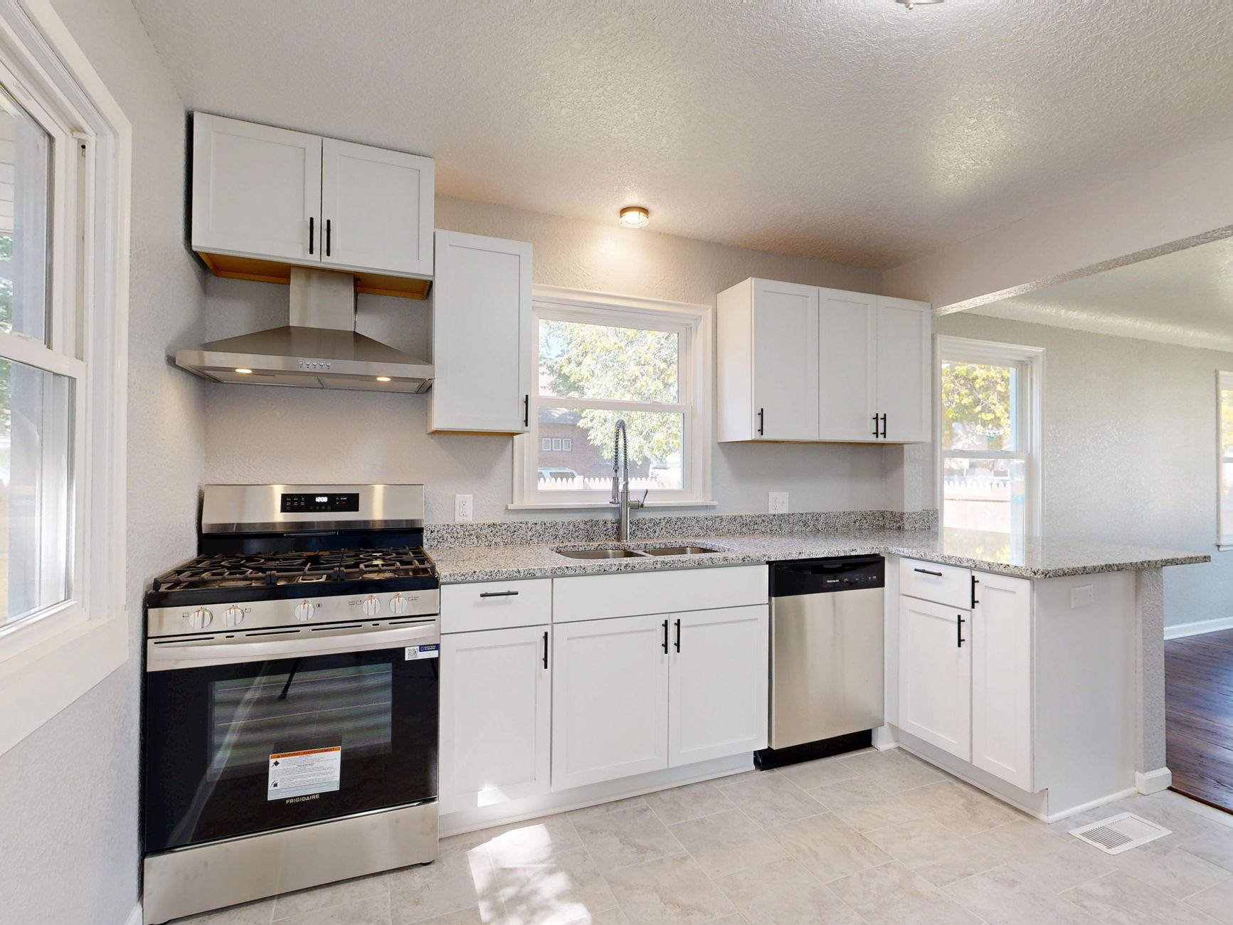 modern white kitchen with stainless steel appliances