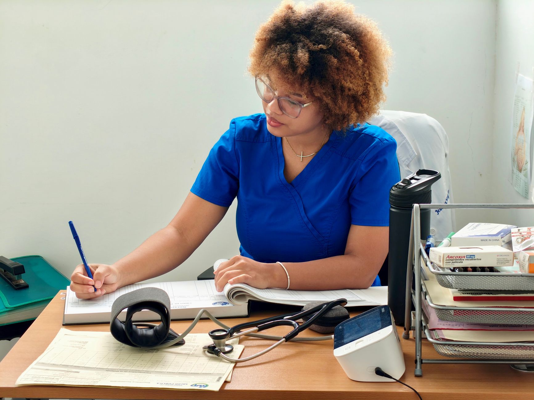 nurse recording patient data in medical office