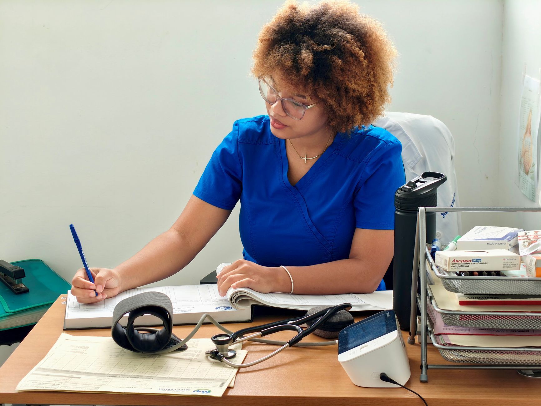 nurse recording patient data in medical office